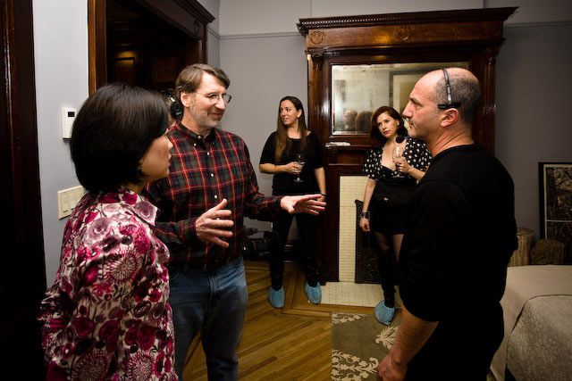 Norm Abram discusses the next scene with homeowner Karen Shen and director David Vos
